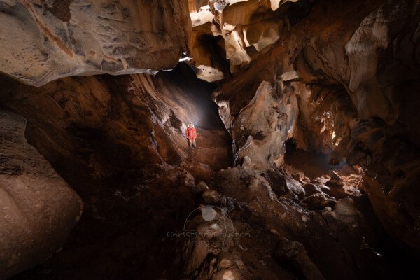 Une grande lame rocheuse coupe en deux la salle du fond. (Grotte de Chironlong, Ardèche)