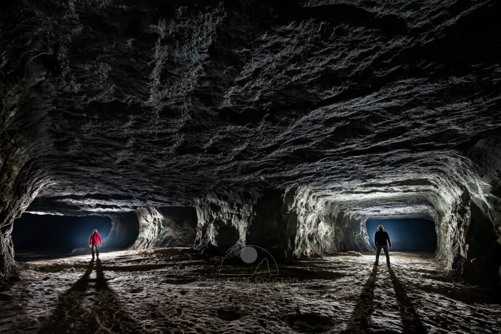 Double galerie avec deux spéléologues. (Carrière de Vallabrègues, Vaucluse)