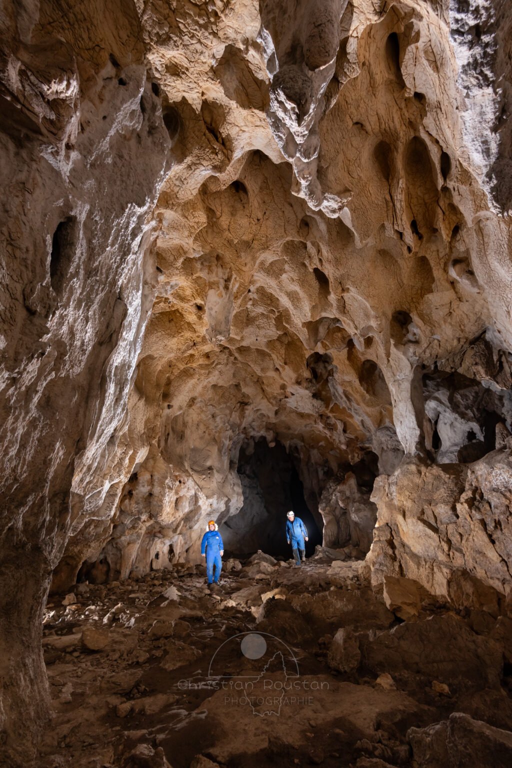 Deux spéléo en bleu dans la grotte du Déroc. (Grotte du Déroc, Ardèche)